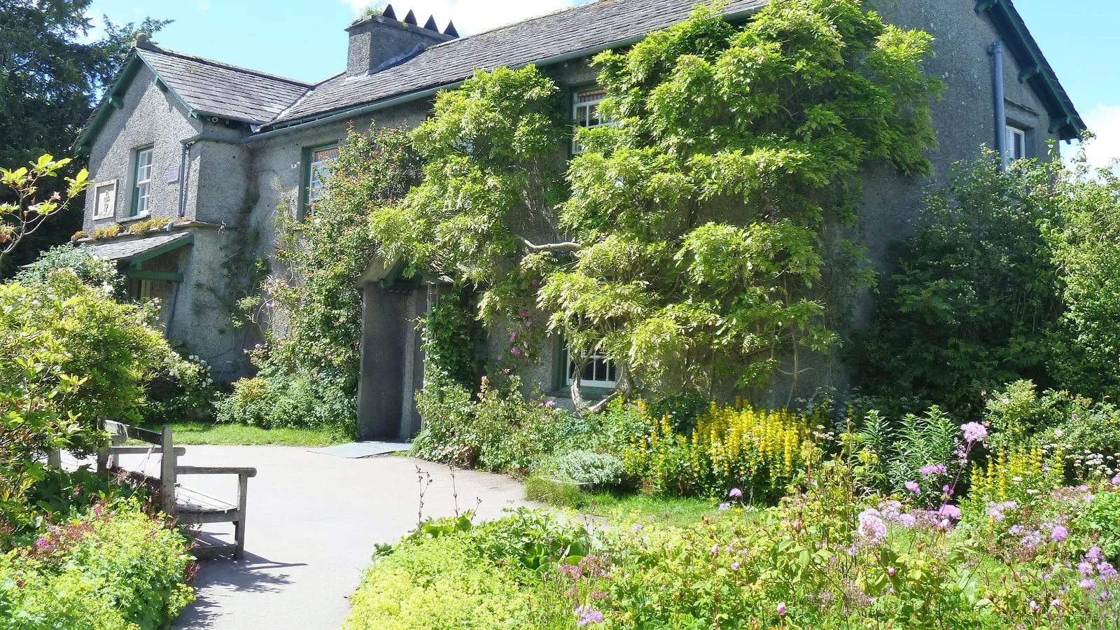 บ้าน Beatrix Potter หรือ Hill Top ที่ Near Sawrey กับทางเดินหินและสวนดอกไม้หน้าบ้าน ภาพถ่ายเมื่อ 21 มิถุนายน 2019