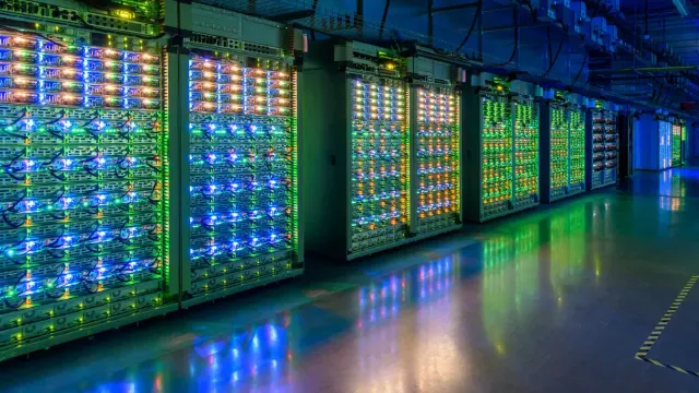 แถวเซิร์ฟเวอร์ไฟสีเขียวและน้ำเงินภายในศูนย์ข้อมูล St. Ghislain ของ Google ภาพประกอบเรื่องส่วนลดผูกสัญญาคลาวด์