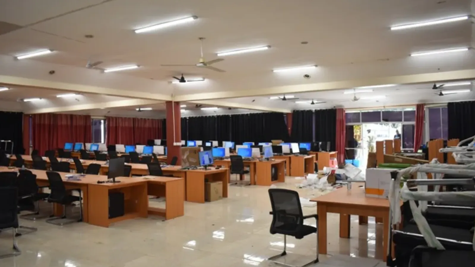 ห้องที่ INTERPOL ระบุว่าเป็นคอลเซ็นเตอร์ต้องสงสัยว่าใช้หลอกลวงในยูกันดา มีโต๊ะคอมพิวเตอร์เรียงเป็นแถว พบในปฏิบัติการ Serengeti III