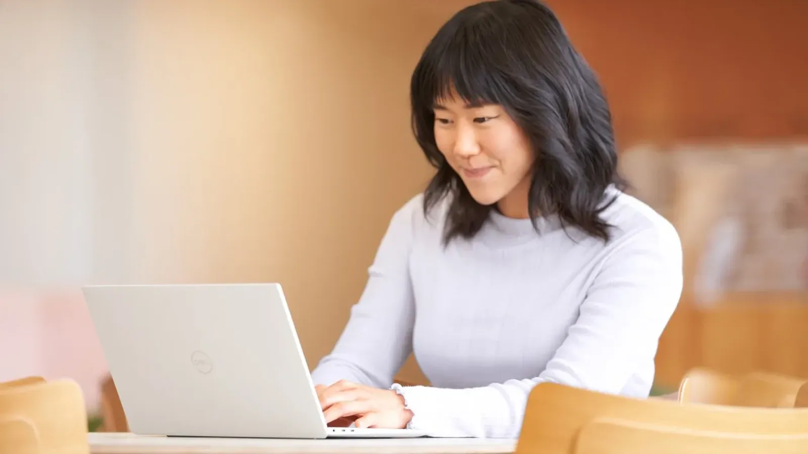 พนักงานใช้แล็ปท็อปในสำนักงาน ภาพจาก Microsoft ประกอบบทความ Microsoft 365 E7 ราคาและการเทียบแผน