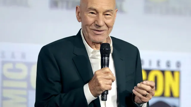 แพทริก สจ๊วต ถือไมโครโฟนบนเวที San Diego Comic-Con เมื่อ 20 กรกฎาคม 2019 ในเวทีเปิดตัวซีรีส์ Star Trek: Picard ซึ่งเป็นการกลับมารับบทกัปตัน Picard