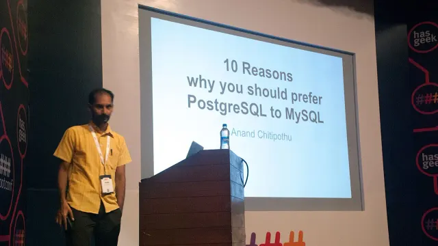 ผู้บรรยายยืนหน้าสไลด์เรื่อง PostgreSQL ในงาน Rootconf 2015