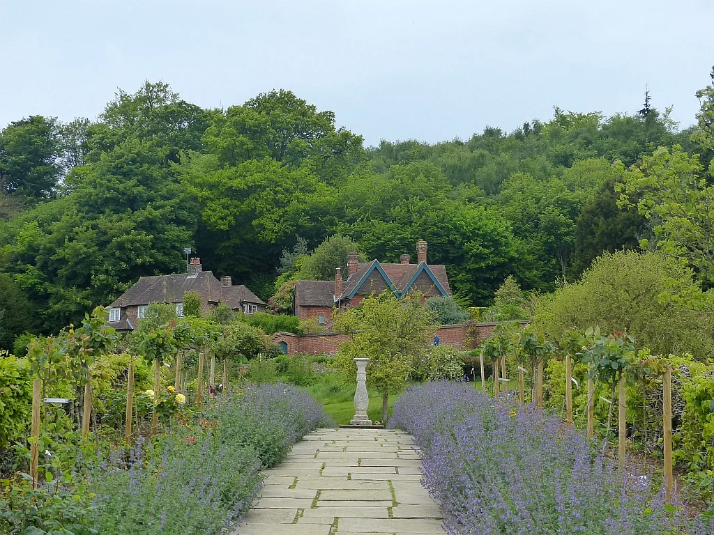 ทางเดินในสวนล้อมกำแพงของบ้าน Chartwell ขนาบด้วยแปลงไม้ดอกสีม่วง ภาพถ่ายเมื่อ 15 พฤษภาคม 2017