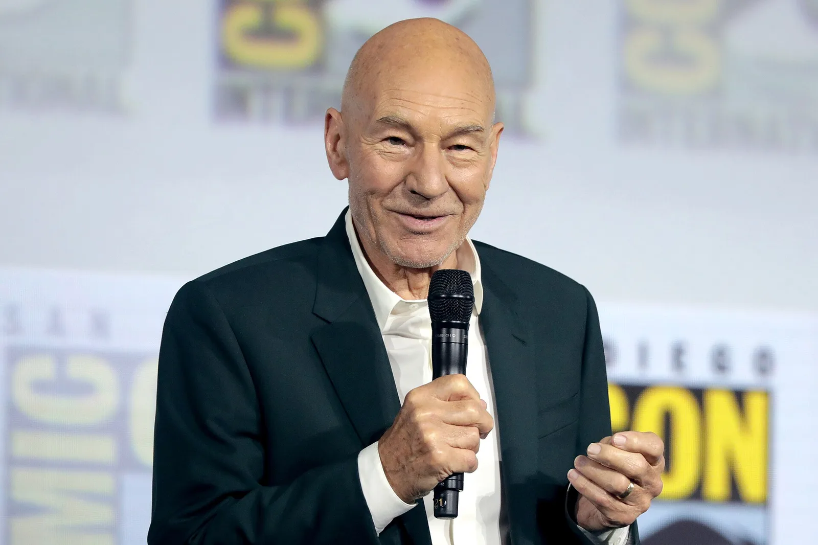 แพทริก สจ๊วต ถือไมโครโฟนบนเวที San Diego Comic-Con เมื่อ 20 กรกฎาคม 2019 ในเวทีเปิดตัวซีรีส์ Star Trek: Picard ซึ่งเป็นการกลับมารับบทกัปตัน Picard