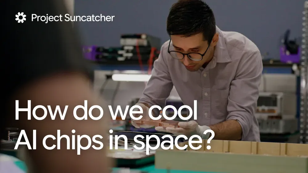 ชายสวมแว่นก้มทำงานบนโต๊ะในห้องแล็บ ในภาพปกวิดีโอหัวข้อ How do we cool AI chips in space
