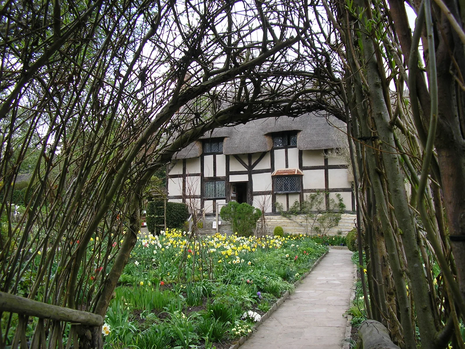 ซุ้มไม้เลื้อยเหนือทางเดินในสวนของ Anne Hathaway's Cottage